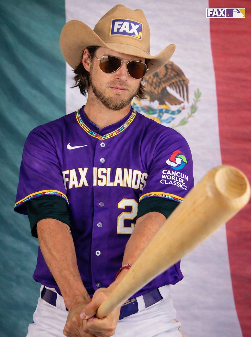 Baseball player Josh Reddick in a cowboy hat and sunglasses grips a bat. Wearing a purple "FAX ISLANDS" jersey, posing before a Mexican flag backdrop.
