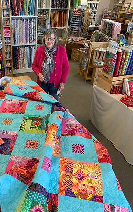 Carolyn by colorful quilt.jpg