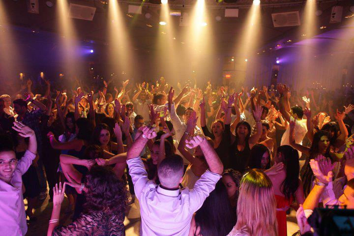 Packed dance floor with event lighting in South Florida