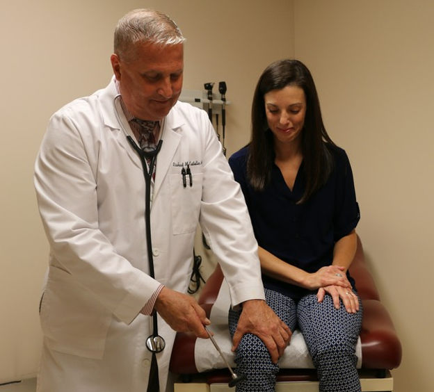 Dr. Kastelic testing reflexes