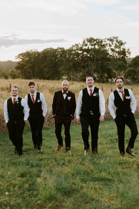 Groomsmen walking through a field, formal attire, photography wedding photographer brisbane