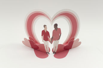 A hand assembled pop up Valentine's Day card with a digital design, showing two young men holding hands. There is a rainbow heart archway behind them .