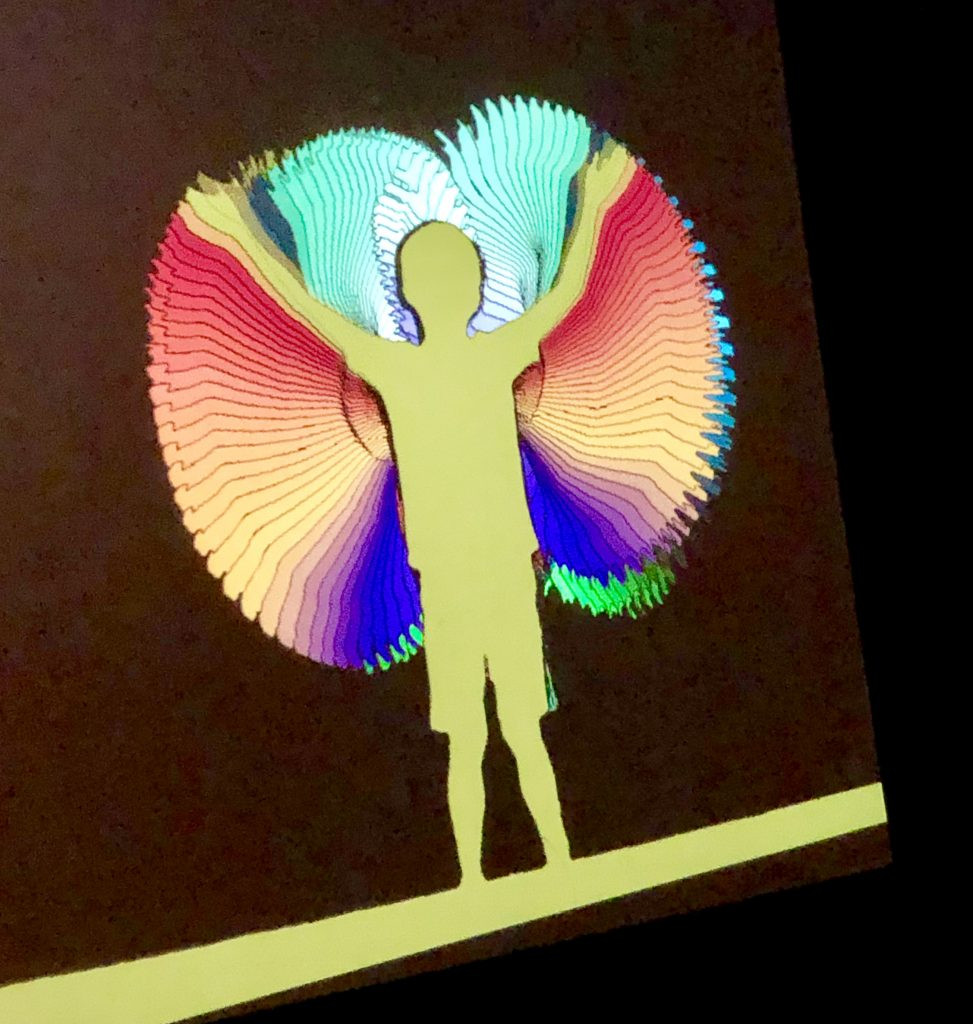A child playing with light on a screen at the Children's Museum.