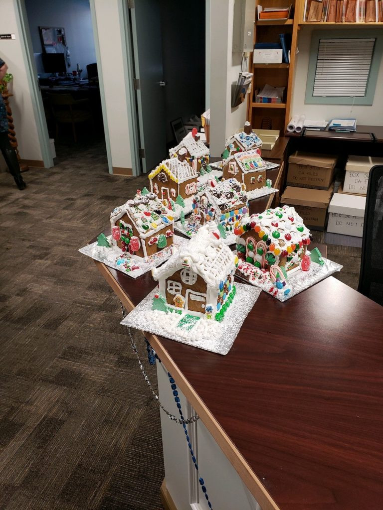 Gingerbread houses displayed on the end of a counter.