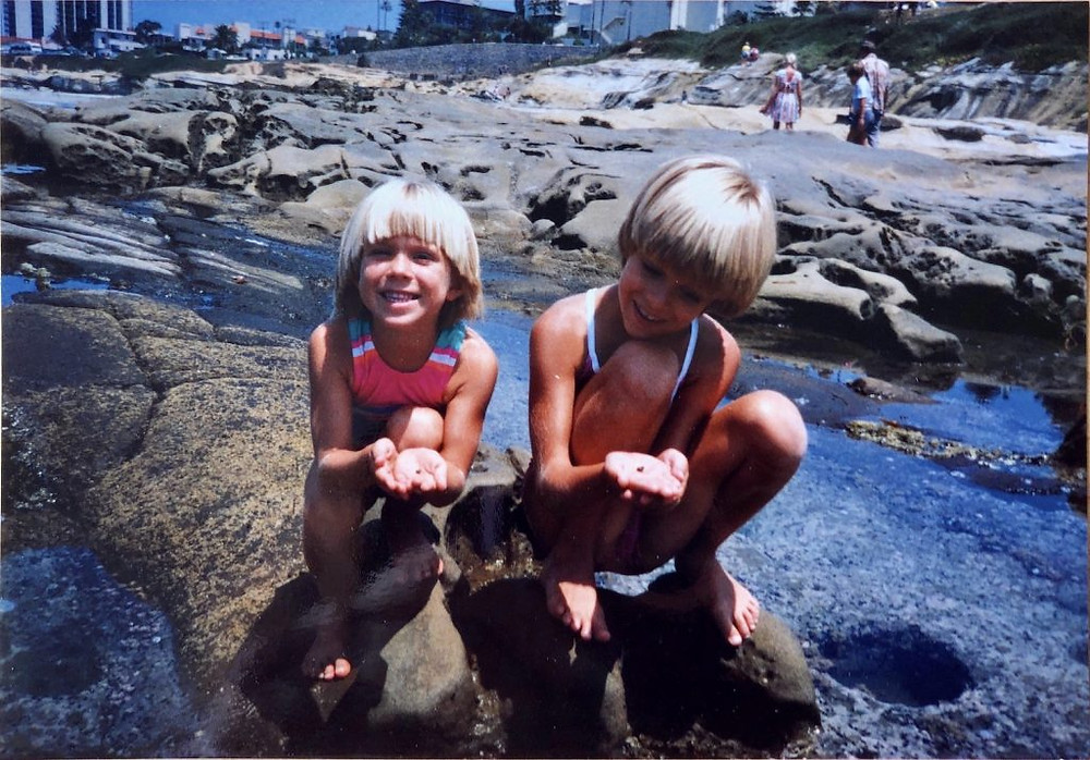 Haley and Lindsey Neef as kids playing outside.
