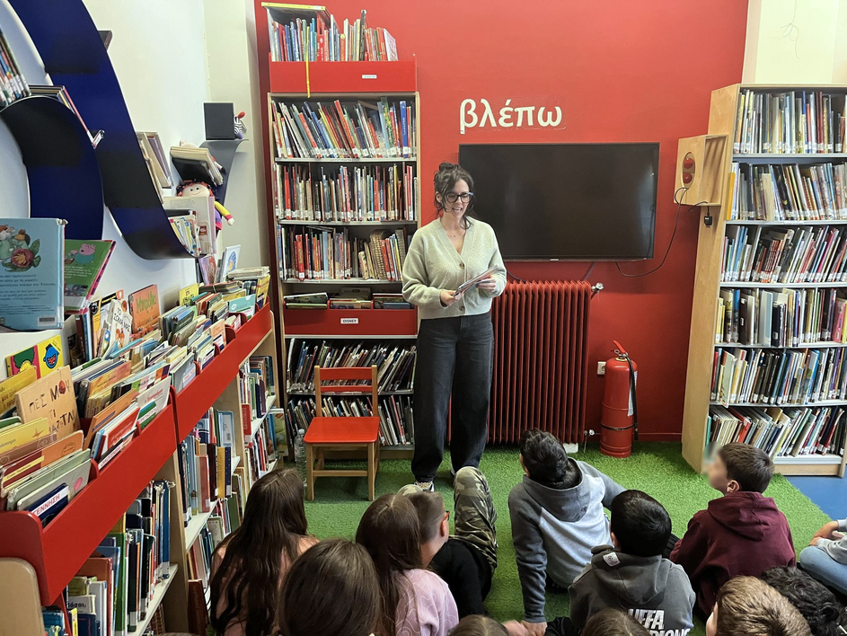 παιδιά καθισμένα στο πάτωμα και η συγγραφέας να αφηγείται