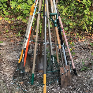 a pyramid of tall garden tools