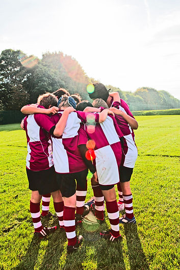 teenage-schoolboy-rugby-team-in-huddle-2022-03-04-01-48-56-utc.jpg