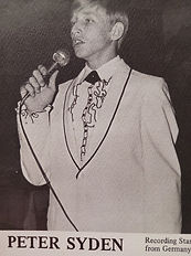 Peter Syden, German recording star, singing into a microphone.