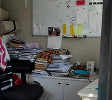 Home Office full of stacks of paper work, clutter and chaos before being organised by Decluttering Crew