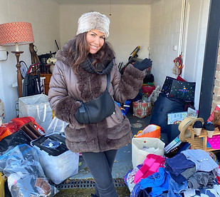 Georgina stood in front of a Storgage Container bursting with extra belongings of a family with no space to store them at home