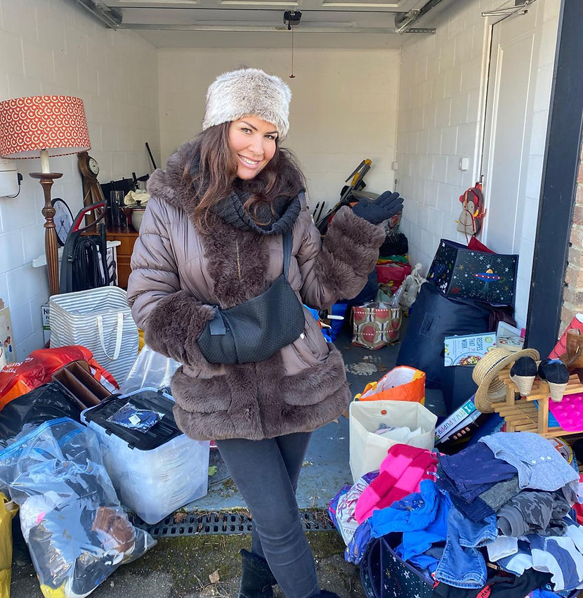 Georgin stood in from of a Storage container full of extra boxes a family can't store at home.