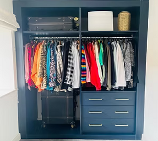 Wardrobe full of clothes.