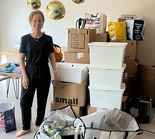 Alix Stood By A Stack of Packed Boxes