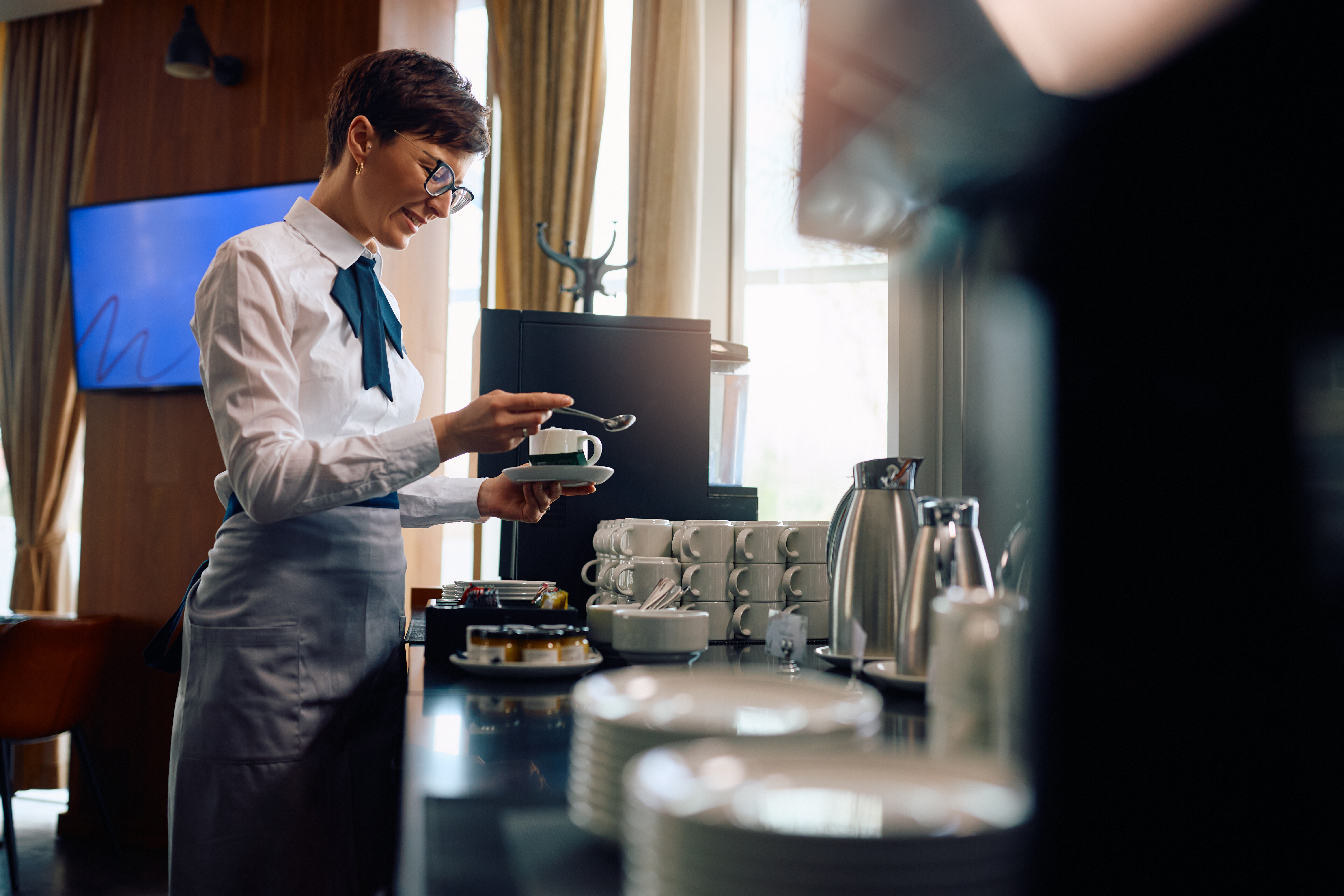 smiling-hotel-waitress-making-a-cup-of-tea-2026-03-16-03-30-35-utc.jpg