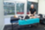Physiotherapist assessing a young athlete's knee during a rehabilitation session at Pure Sports Medicine clinic.