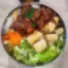 Vietnamese vermicelli bowl with grilled pork, egg rolls, fresh lettuce, pickled carrots, and rice noodles