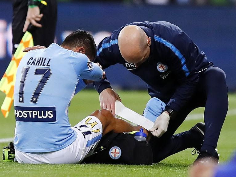 Physio taking care of player injury during play pause