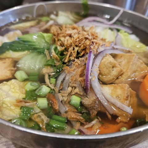 Vietnamese soup with tofu, vegetables, and fried onions