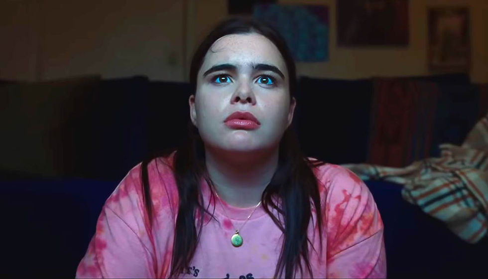 Woman starring at TV while sitting on floor.