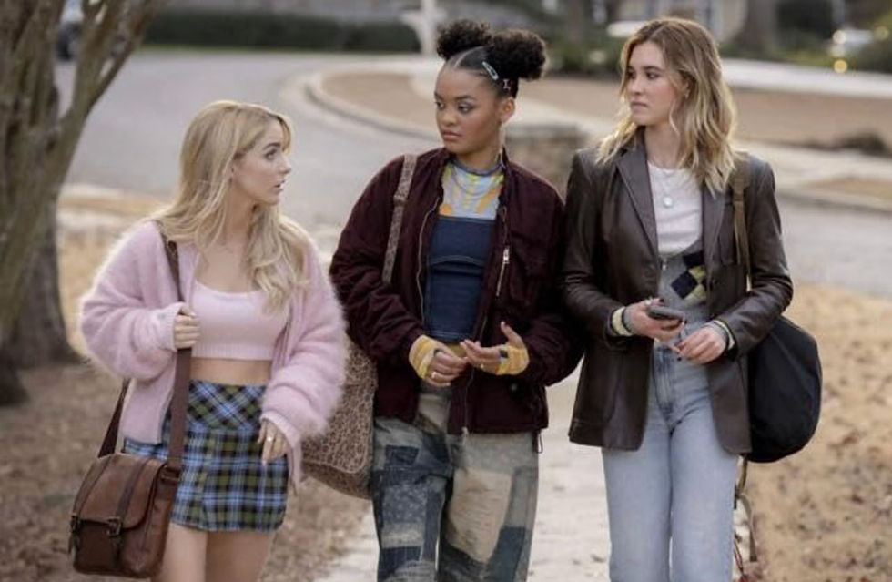 Isabel May, Celeste O'Connor, and Mckenna Grace walking down the sidewalk on a fall day.