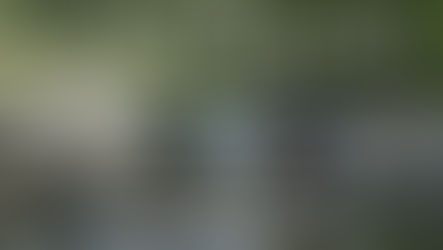 Kurt Russell and Matthew Fox sitting on rocks in a river with fishing poles