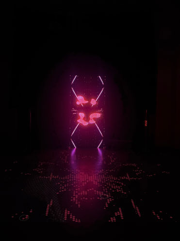 Glowing digital figure in a dark installation space, Perceive or Receive (2025) by Elin Fiorentino