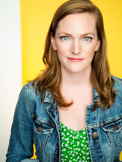 headshot of actor/actress Johny Walsh wearing a green dress and denim jacket.