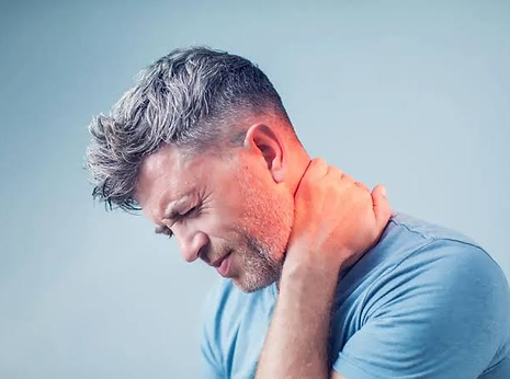 Man holding the back of his neck due to neck pain and stiffness