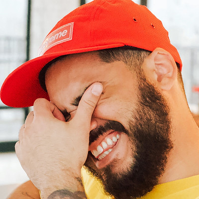 golfer with beard and red hat laughing at a joke