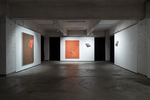 Installation view of and i love you dearly, Michael Rikio Ming Hee Ho’s 2026 solo exhibition at Hart Haus. The gallery space shows Ho’s text-based conceptual paintings, shaped canvases, and trompe-l’œil wall works installed across white walls within an industrial concrete interior. The exhibition uses distorted typography, spatial illusion, landscape imagery, and poetic language to examine emotional selfhood, tenderness, memory, and post-social-media forms of inner speech.