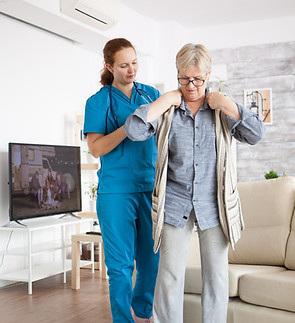young-female-nurse-helping-senior-woman-get-dressed-nursing-home_edited.jpg