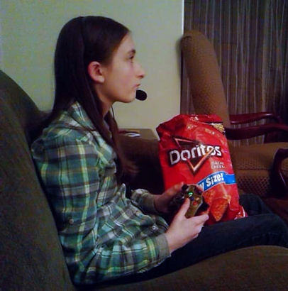 young gamer girl eating doritos