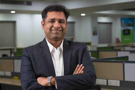 Lifestyle Portrait of a CEO with his office in the background for personal brand building, investor reports, press releases, magazine articles.