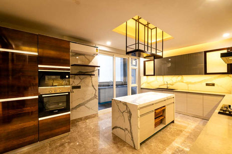 A beautifully appointed kitchen with an island and premium storage modules captured by Arch IQ Photography.