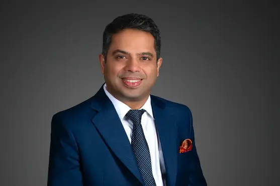 Professional headshot of a CFO on dark gray gradient backdrop, optimized for LinkedIn, pitch decks, annual reports and investor presentations shot by a professional photographer in Gurgaon, Delhi NCR.