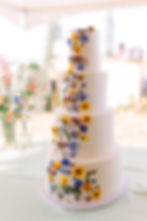 Four-tiered wedding cake with pressed dried florals