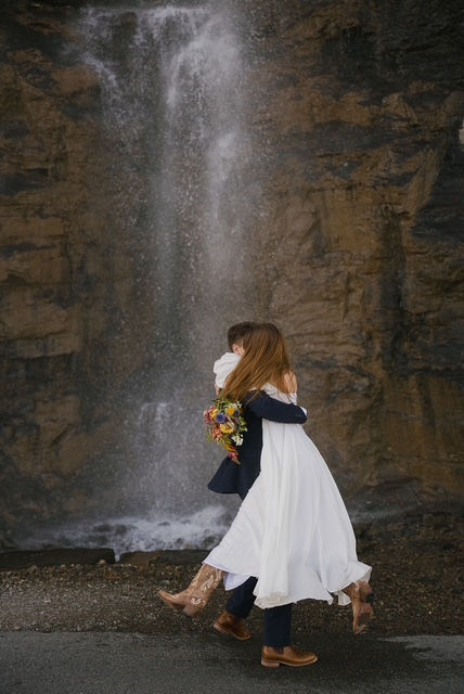 Elopement couple in Glacier Park in front of weeping wall