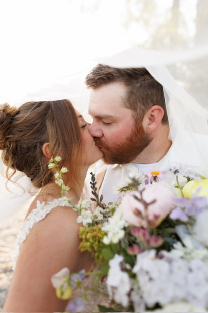 June elopement kissing in Glacier Park