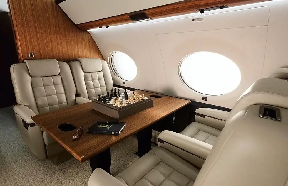 Spacious executive cabin interior of a luxury private jet charter ready for passenger boarding.