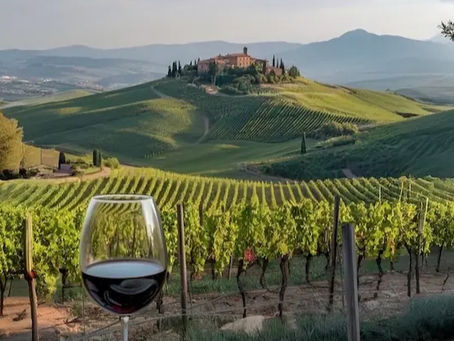 A luxury private villa terrace in Tuscany featuring local wine and pasta overlooking scenic rolling hills and vineyards