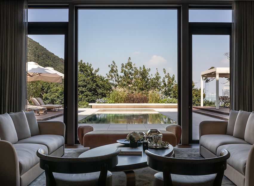 Exclusive luxury residential architectural photography of the Mount Nicholson penthouse in Hong Kong. Interior design by Studio 1618, showcasing a grand open-plan living space, bespoke imported stone flooring, panoramic floor-to-ceiling windows with Peak views, and sophisticated, ultra-high-net-worth spatial curation.