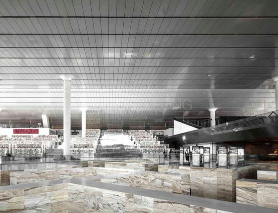Interior architectural photography of Qatar National Library by Edmon Leong, showcasing visionary open-plan layout, tiered bookshelves, and bright natural desert lighting engineered by OMA.