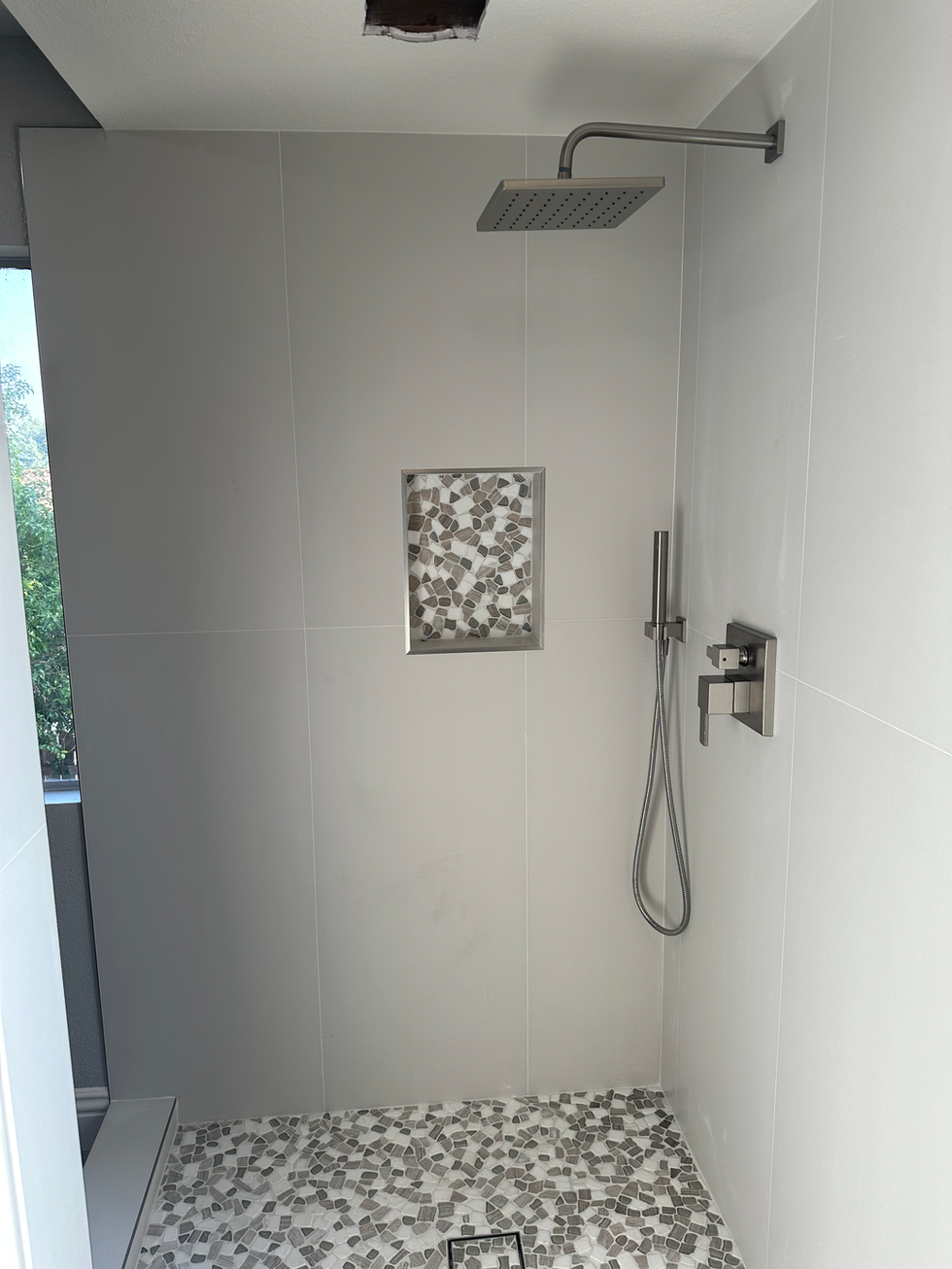 Custom shower wall tiling and design detail.