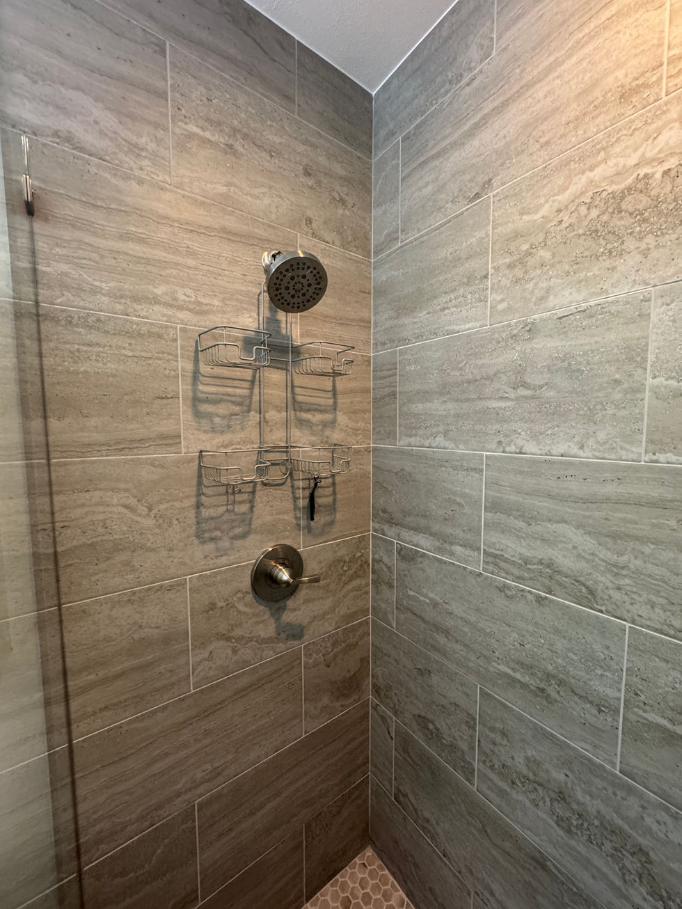 Modern white double vanity with rectangular undermount sinks and brushed gold faucets.