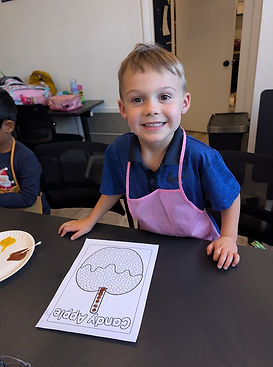 BOY AT STEAM CAMP PAINTING CANDY APPLE.jpg