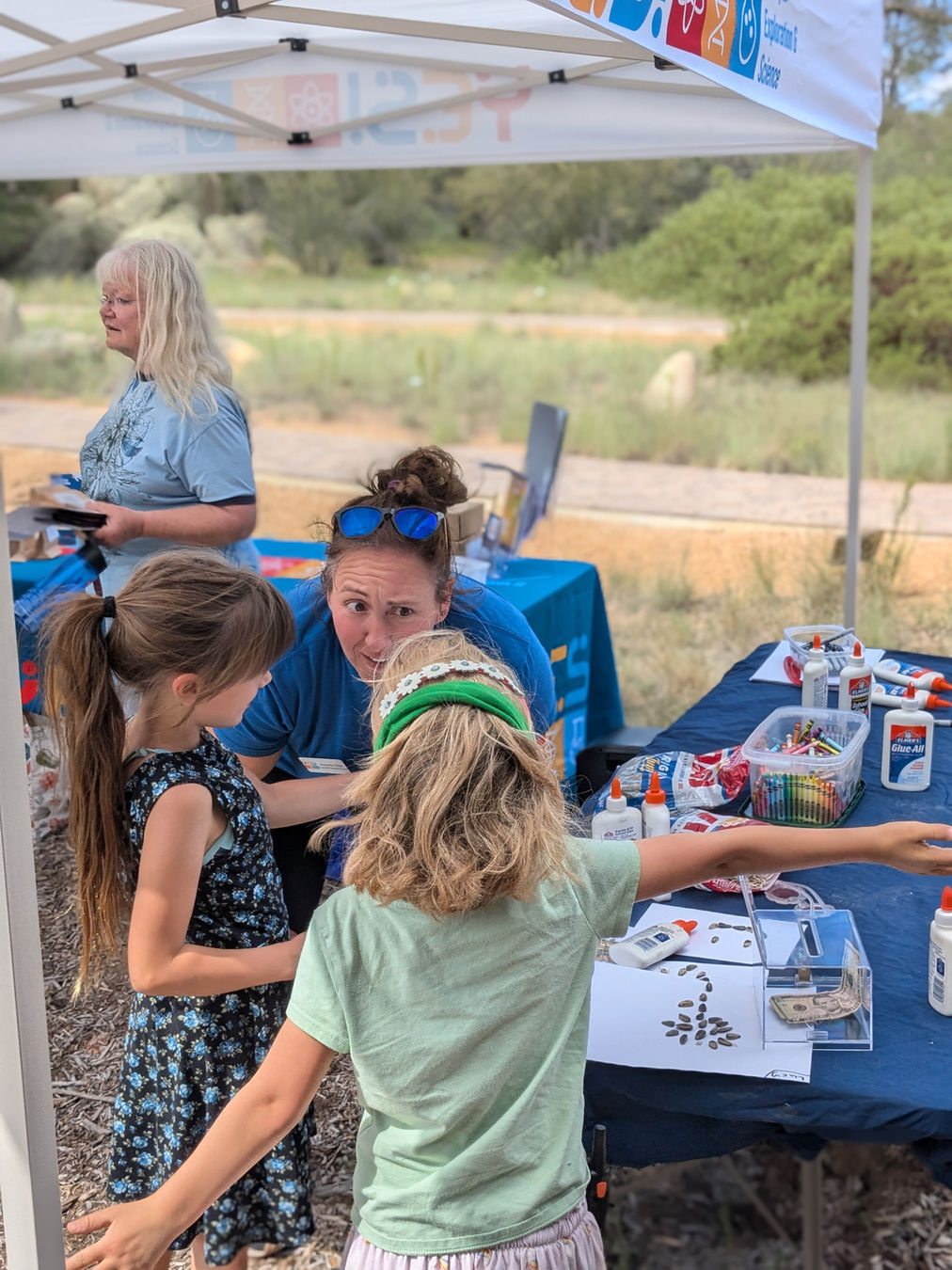 Founder Amanda Voss working with 2 kids at a Nature Ninos outreach event!
