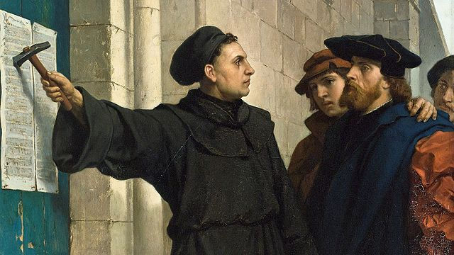 A couple of man looking at a paper