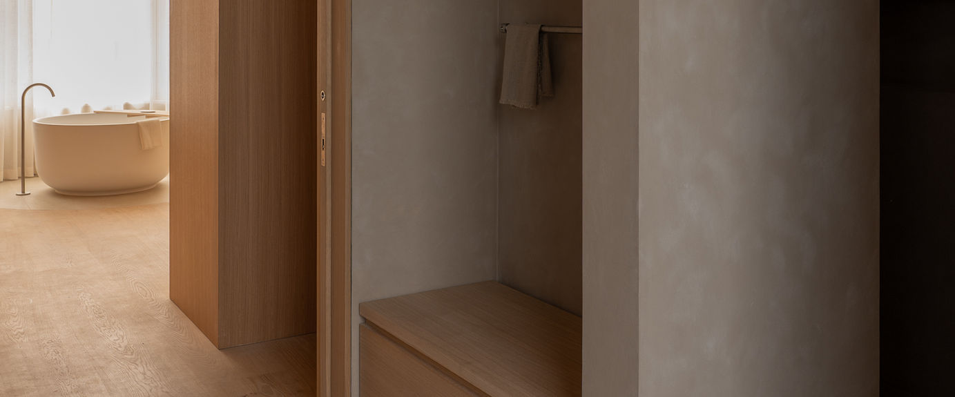 Tranquil bedroom suite featuring a minimal freestanding bathtub bathed in soft, natural light. Richard Bell. 