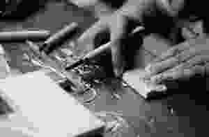 grayscale photo of person carving block